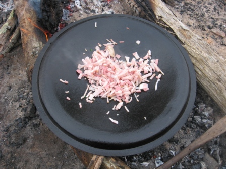 Step_1_Preheat___prop_up_lid_over_coals_Add_bacon.jpg
